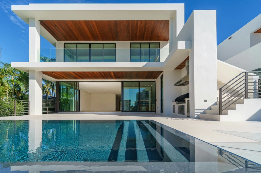 A large white house with a pool in the middle of it.