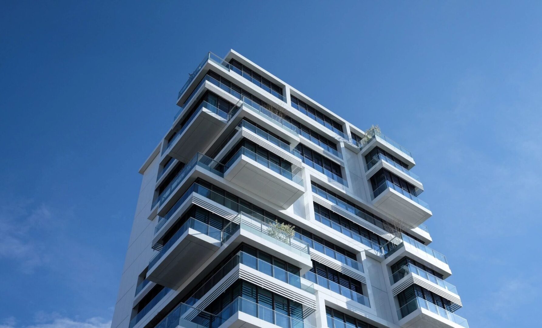 A tall building with many windows and balconies.